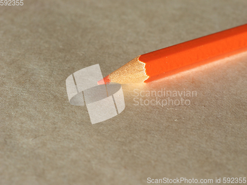 Image of Orange pencil over paper