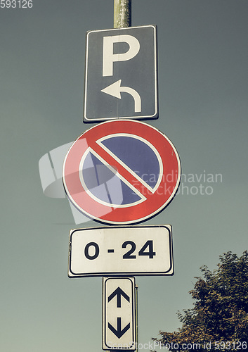 Image of Vintage looking No parking sign over blue sky