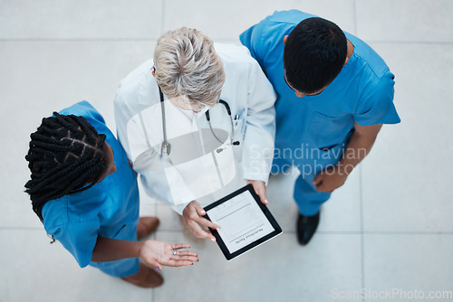 Image of Medical, consulting and teamwork with doctors and tablet and top view for collaboration, review or meeting. Healthcare, research and planning with nurse and senior employee for digital and technology