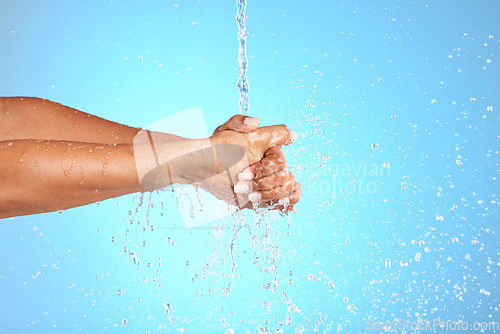 Image of Hands, water and wash for clean hygiene, health or wellness against a blue studio background. Hand rinsing, washing or cleaning for fresh hygienic cleanse or hydration in care for skin on mockup