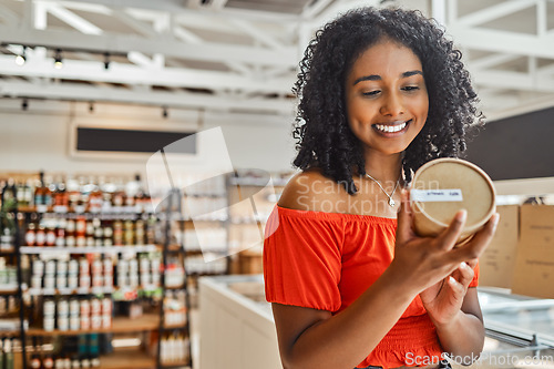 Image of Supermarket, black woman and shopping, groceries and happy with product in retail shop, customer check ingredients. Grocery store, sale on food and drink, happiness with shop choice and buying.