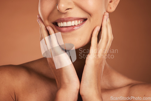 Image of Dental, smile and teeth, oral care and woman on brown studio background. Health, wellness and closeup of female model with hands on face showing her natural looking veneers, healthy mouth and lips