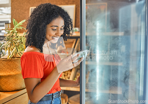 Image of Supermarket, grocery store and customer black woman shopping for healthy food in fridge happy with price discount, sale or promotion. Groceries, small business store and vegan girl with green choice