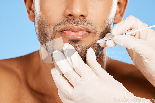 Image of Beauty, skincare and face of man with botox injection on blue studio background. Healthcare, medical and male model with aesthetic plastic surgery treatment, dermatology or facial anti aging filler.