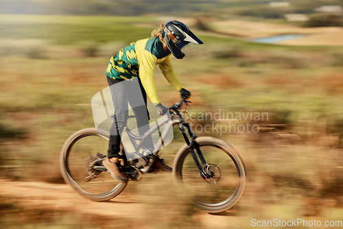 Image of Speed, action and man on mountain bike for dirt racing sports, riding on nature trail. Sports, mountain biking and blur of athlete cycling fast on dirt road for fitness, adrenaline and adventure