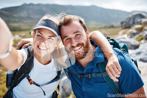 Image of Hiking, happy and couple taking a selfie by a mountain in nature while walking or trekking with freedom in Canada. Smile, memory and healthy woman loves taking pictures when traveling on fun holidays