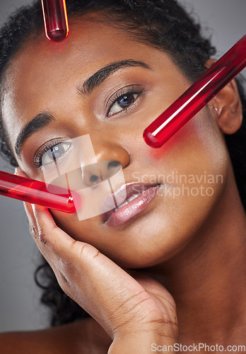 Image of Face, beauty and serum with a model black woman in studio on a gray background for health or wellness. Portrait, skincare and antiaging with a female closeup to promote a product for healthy skin