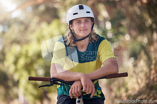 Image of Bicycle, fitness and athlete cycling in a forest training, cardio exercise and sports workout outdoors in nature. Biker, young and healthy male teenager enjoys traveling on a fun adventure journey