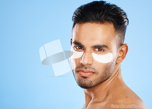 Image of Skincare, eyes patch and man portrait of beauty product, body cosmetics and wellness, facial treatment and aesthetic health on studio blue background. Arab guy face portrait, hydration and self care