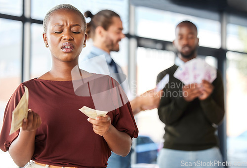 Image of Black woman, unequal pay and confused by wages, paycheck and quote in office, frustrated and annoyed. Angry, woman and reading salary slip with happy colleagues in background, unfair and compensation