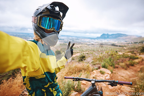 Image of Cycling fitness, selfie and hand, peace and sign by cyclist riding along mountain, adventure and exercise. Nature, bike and picture by athletic man on solo journey, enjoy scenic view in South Africa