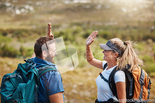 Image of High five, success and couple hiking in nature with motivation, goal and support in Puerto Rico. Teamwork, celebration and man and woman excited about travel adventure on a mountain for holiday