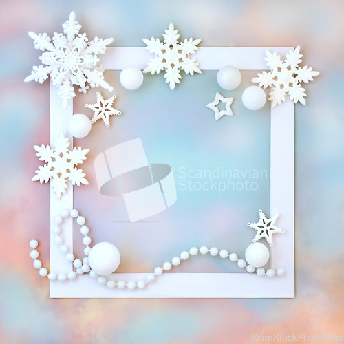 Image of Christmas White Bauble Decorations on Rainbow Sky Background