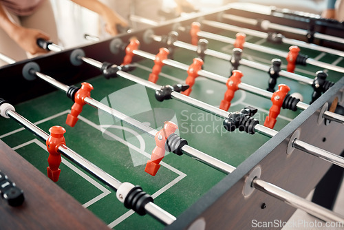 Image of Foosball, game and fun with people playing a game inside of a clubhouse or at a party together. Soccer, table and competition with friends bonding over a match of football together for recreation
