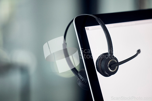 Image of Call center, laptop screen and headset Laptop in modern office for customer service, contact us and virtual information technology support. Telemarketing and crm zoom of online communication mock up