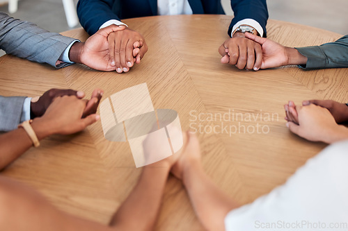 Image of Teamwork, trust and business people holding hands in meeting for support, unity and agreement. Collaboration, diversity and group of workers at desk with joined hands in circle, united together