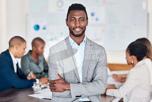 Image of Leadership, meeting and planning with a black man and his business team in the boardroom for strategy. Portrait, leader and collaboration with a male manager standing arms crossed in his office