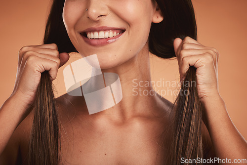 Image of Strong hair woman, studio closeup smile and cosmetic face beauty against orange background. Hair care health, happy cosmetic girl and healthy brunette happiness for wellness model with natural locks