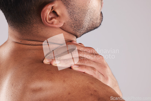 Image of Man hand holding neck pain, hurt and body injured problem in studio. Male model hands from behind suffering with sore body injury, discomfort and strain or muscle sprain from fractured joints