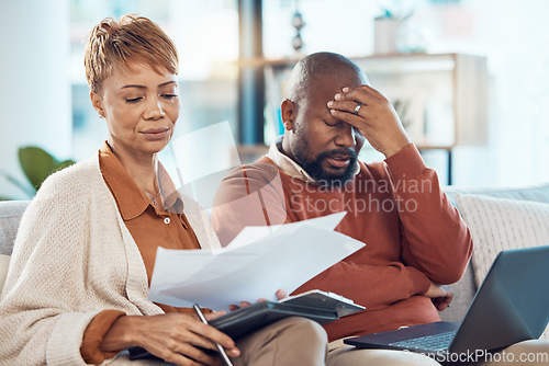 Image of Black couple, stress and laptop in finance debt, expenses or mortgage bills together on the living room sofa at home. Man and woman suffering in financial pressure, payments or issues on computer