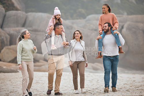 Image of Family, children and beach with grandparents, parents and grandkids walking on the sand at the coast together. Summer, travel and love with a man, woman and kids bonding on a coastal walk outdoor