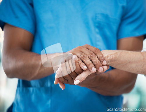 Image of Hands, support and nurse helping patient in hospital, care and empathy for people. Healthcare, assistance and black man or doctor holding hands of senior person for comfort after cancer diagnosis.