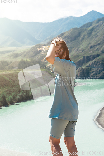 Image of woman on the confluence of two rivers Katun and Chuya in Altai mountains, beauty summer day