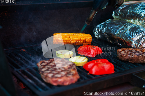 Image of Pork meat steaks on the grill