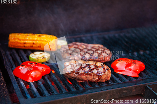 Image of Pork meat steaks on the grill