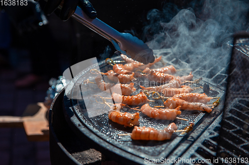 Image of A professional cook prepares shrimps