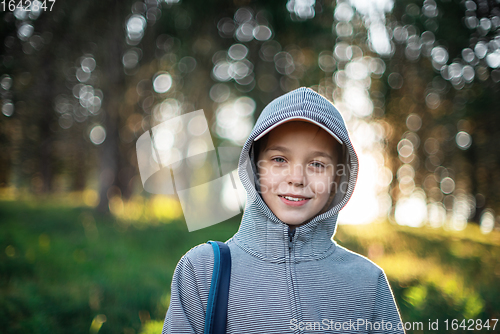 Image of woman walking early in summer forest area