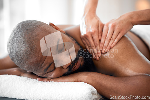 Image of Relax man, spa and back massage for luxury wellness, therapy, healing and skincare. Therapist touch body, muscle and reflexology of sleeping black man on salon bed, stress relief and holistic detox