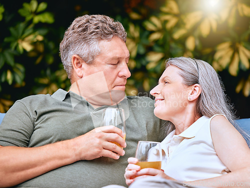 Image of Love, juice and senior couple talking while relaxing outdoor in the garden at their home in summer. Happy, conversation and elderly man and woman in retirement resting together at their house.