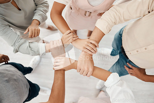 Image of Top view, business people or holding wrist in support, growth power or marketing community, team building or office trust. Creative teamwork, collaboration success or men with women diversity circle