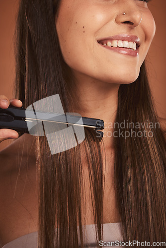 Image of Woman flat iron, closeup hair care and cosmetic beauty with smile against brown studio background. Hair health happiness, happy cosmetic girl and hairstyle for wellness with heat, fashion or styling