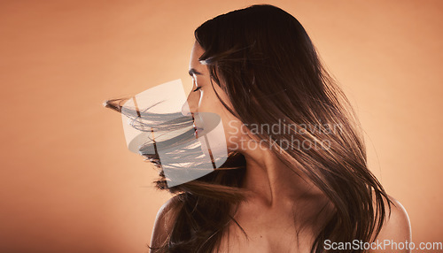 Image of Hair care, beauty and woman with care for body against a brown mockup studio background. Cosmetic, content and young girl model flipping her perfect, soft and healthy hair with mock up space