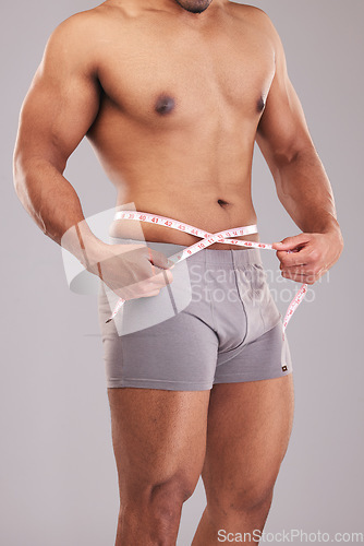 Image of Man, measuring tape and weight loss, goal and body wellness and healthy lifestyle, weight check with target. Fitness model, health and muscle, shirtless and abs with fat or slim in studio background