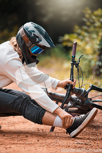 Image of Ankle pain, cycling and man on the ground in a park with injured foot, pain and accident while riding bike for fitness. Foot pain, bicycle and dirt road accident, cyclist and foot injury in a forest