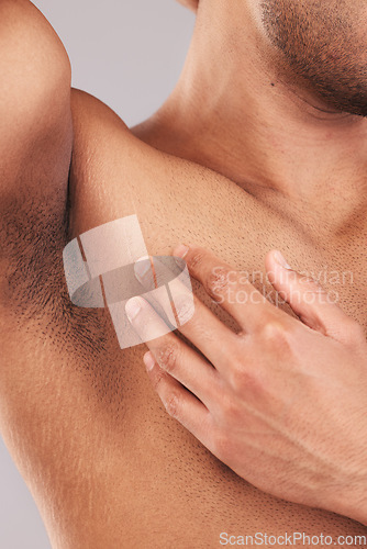 Image of Armpit, clean and hand of man touching skin for health, wellness and beauty at a spa against a studio background. Skincare, luxury and model with cosmetic grooming, hygiene and care for body