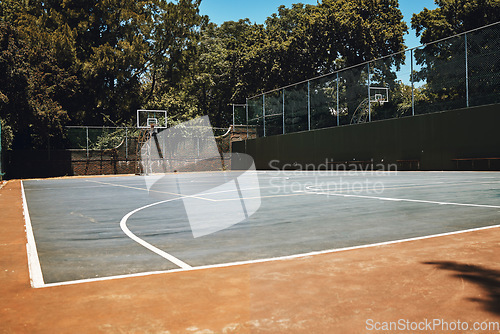 Image of Sports, basketball court and nature, outdoor park and space for youth to exercise, workout and play in summer. Basketball, fitness and health, playground with trees and motivation for playing game.