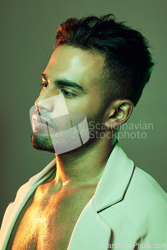 Image of Fashion, green lighting and beauty of male model in neon studio for cosmetics, designer clothes and art for aesthetic background. Man from India posing for skincare, motivation and cool attitude