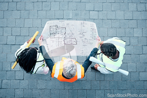 Image of team, architect and blueprint paper while planning building development, engineering and architecture design from above. Floor plan, engineer and teamwork with collaboration, creative idea or talking