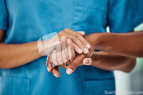 Image of Healthcare, holding hands and doctor with patient in a hospital after bad news of cancer, sickness and disease. Hand, nurse and medical support by woman showing empathy, hope and comfort