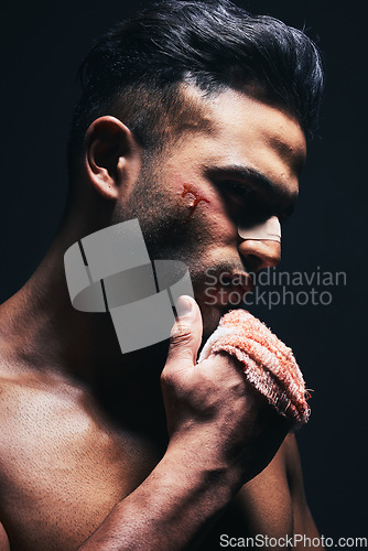 Image of Injury, blood and man with a bandage from fighting or training for MMA or kickboxing in a dark studio. Violence, hurt and guy boxer from Mexico after sports competition isolated by black background.