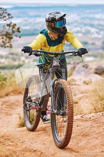 Image of Bike, biker and outdoor sport with athlete and mountain bike, adventure and extreme sports. Fitness, exercise and cyclist ride through dirt track, workout in woods and training with safety helmet.