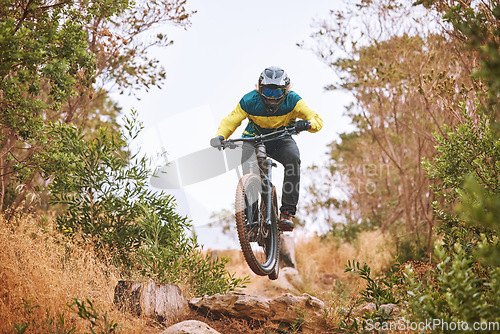 Image of Bike, cyclist and sport, cycling in the woods, fitness and energy with extreme sports outdoor. Bicycle, exercise in nature and helmet for safety, active lifestyle and mountain biking in forest.