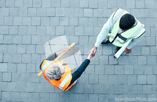 Image of Builder, construction worker and architect handshake with aerial view of teamwork, labor collaboration and industrial project workers. Men shaking hands, thank you and engineering building contractor