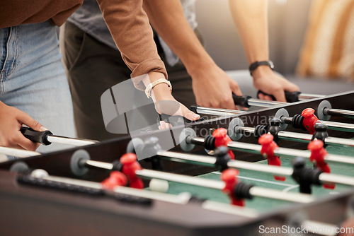 Image of Hands, foosball and table with friends playing a game together indoors for fun or recreation. Football, fun and leisure with a friend group together to play at a party or celebration event