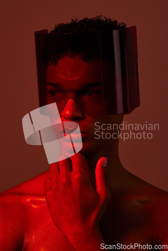 Image of man, face and red light with futuristic glasses for edgy cyberpunk fashion, modern gen z fantasy and sci fi model for beauty. Young black man, vision thinking or designer neon lighting studio