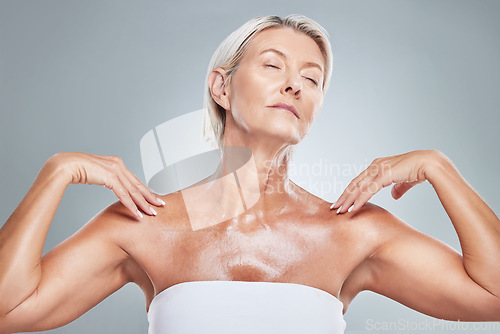 Image of Skincare, skin and senior woman in studio for beauty, grooming and wellness against a grey background. Relax, body and elderly model posing with shine, glow and healthy skin after anti aging product